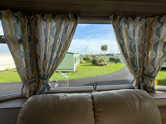 Dining area with panoramic windows and sea views - comfortable meals in luxury caravan at Sands of Luce