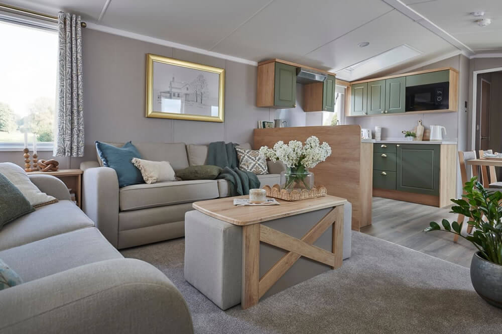 Spacious lounge with contemporary furniture and fireplace - premium living space in Swift Provence caravan