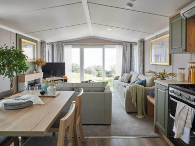 Modern open-plan living and dining area with kitchen in luxury caravan - Swift Provence accommodation